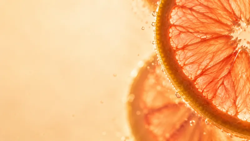 Backlit blood orange slices with tiny bubbles.
